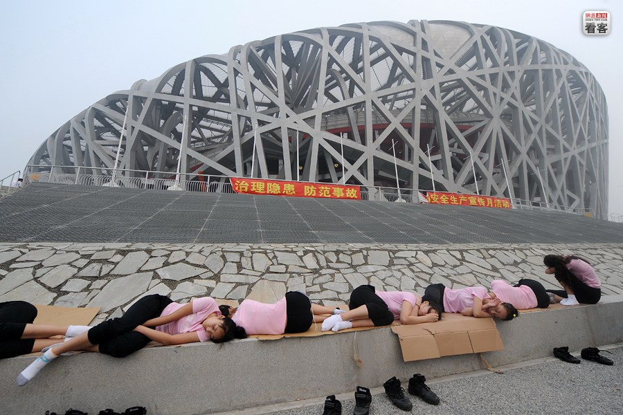 A group of female Olympic volunteers are sleeping outside the 